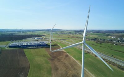 white-wind-turbine-on-green-grass-field-during-daytime