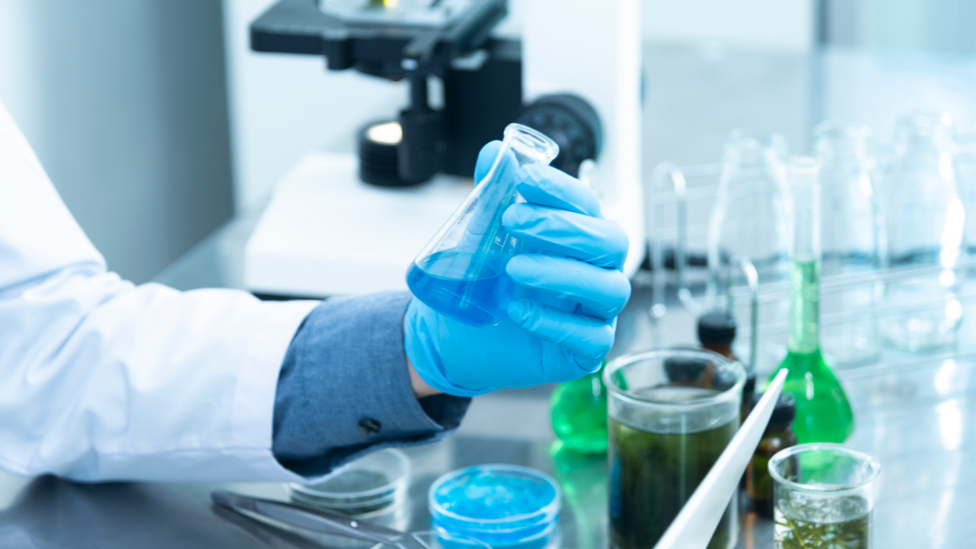 Person holding a test tube in a lab.