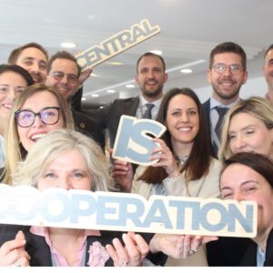 Cooperation is central sign hold by the team