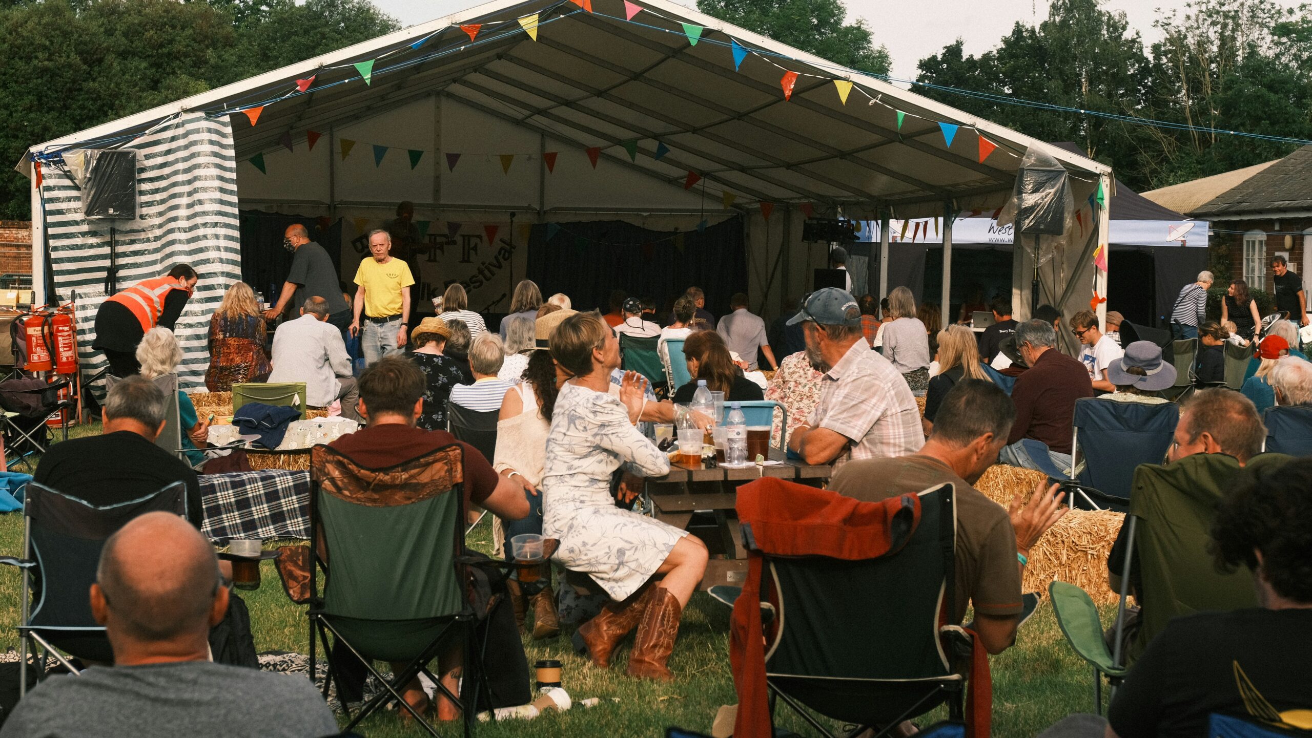 a-group-of-people-sitting-around-a-picnic-table