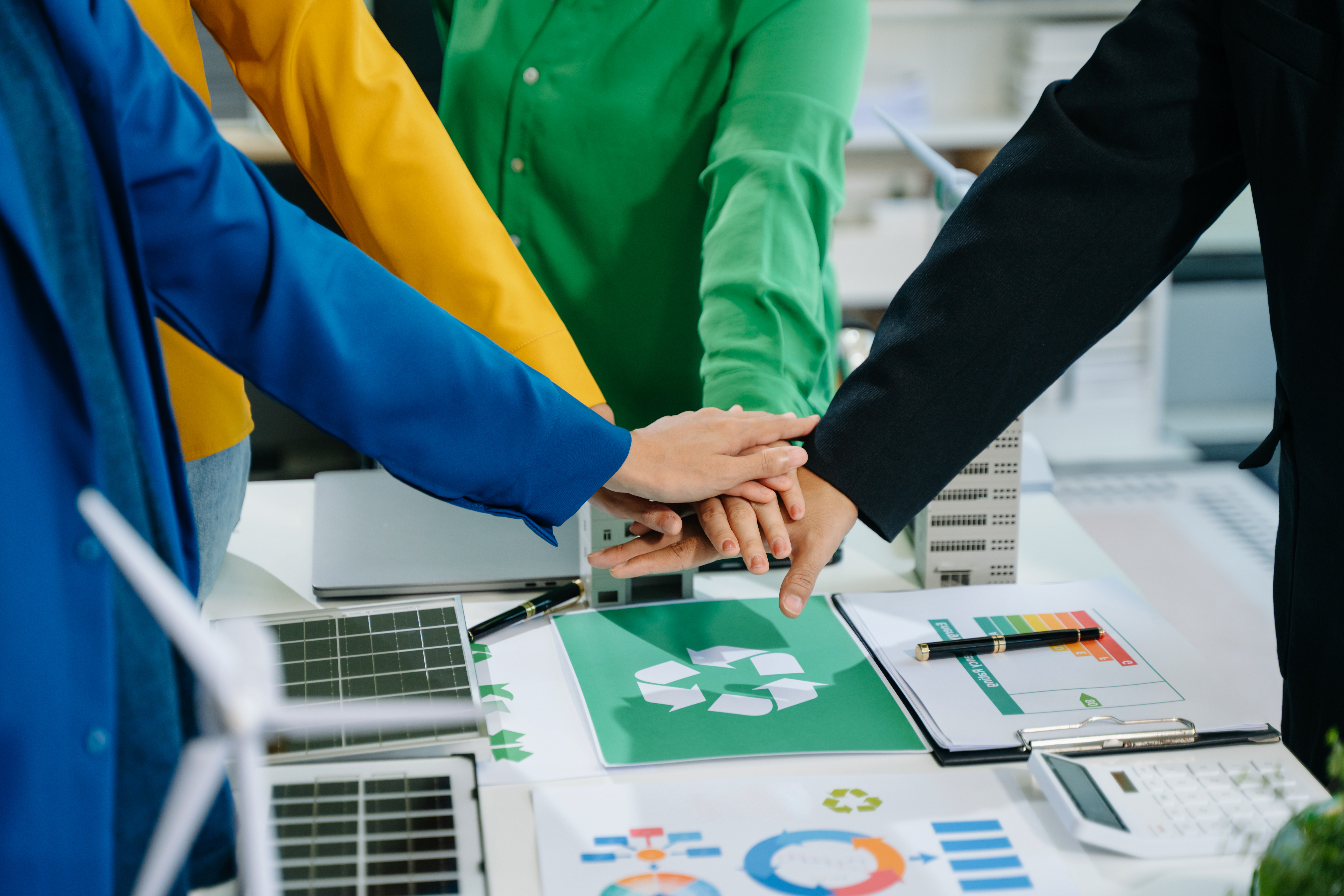 business team people planning and discussing on recycle reduce reuse policy symbol in office meeting room. Green business company and Solar Energy Environment city Concept.