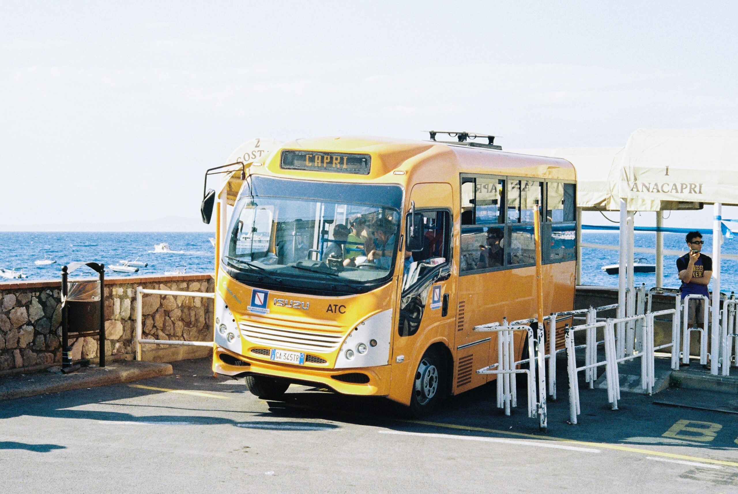 a-yellow-bus-parked-on-the-side-of-the-road
