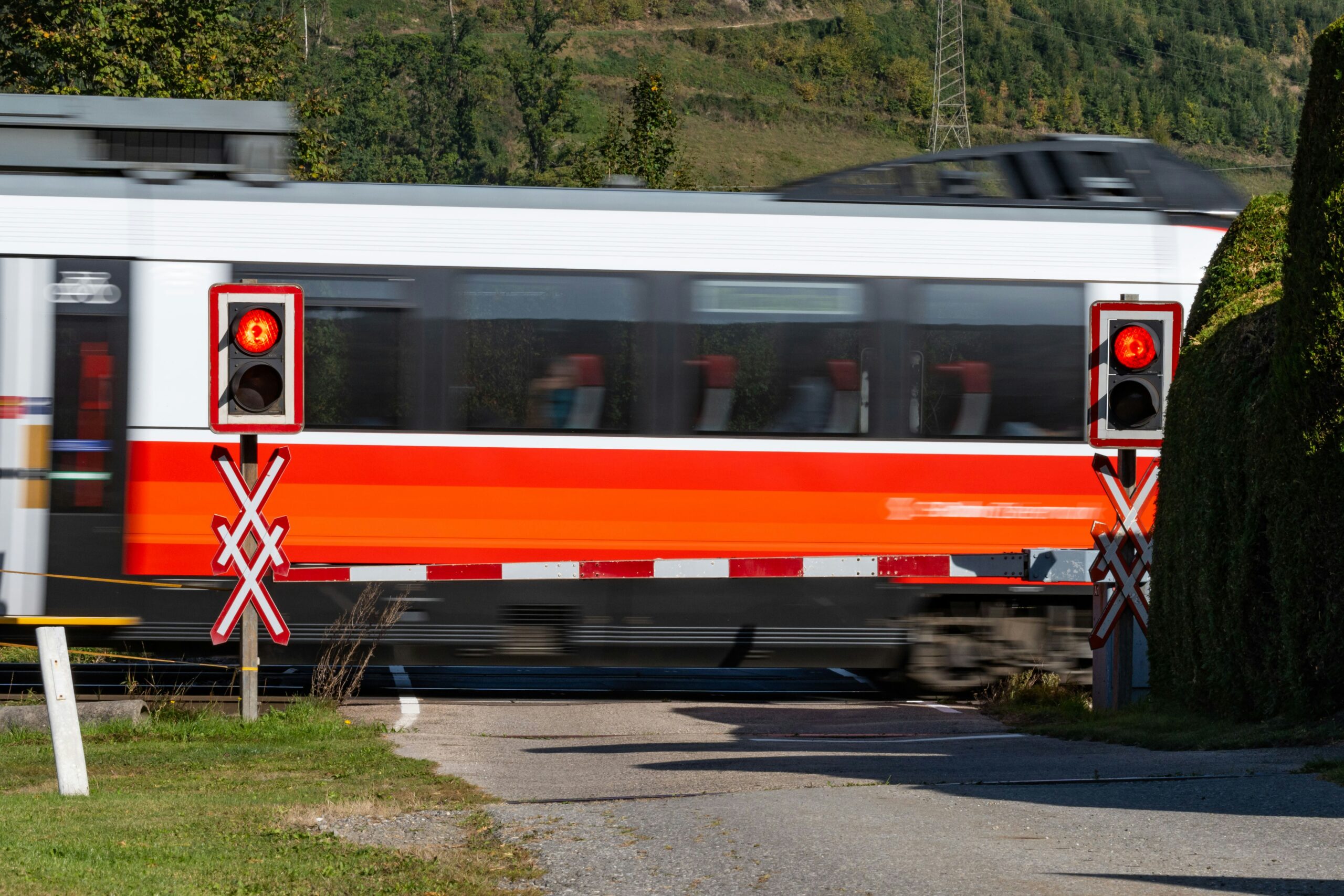 a-red-and-white-train-traveling-down-train-tracks