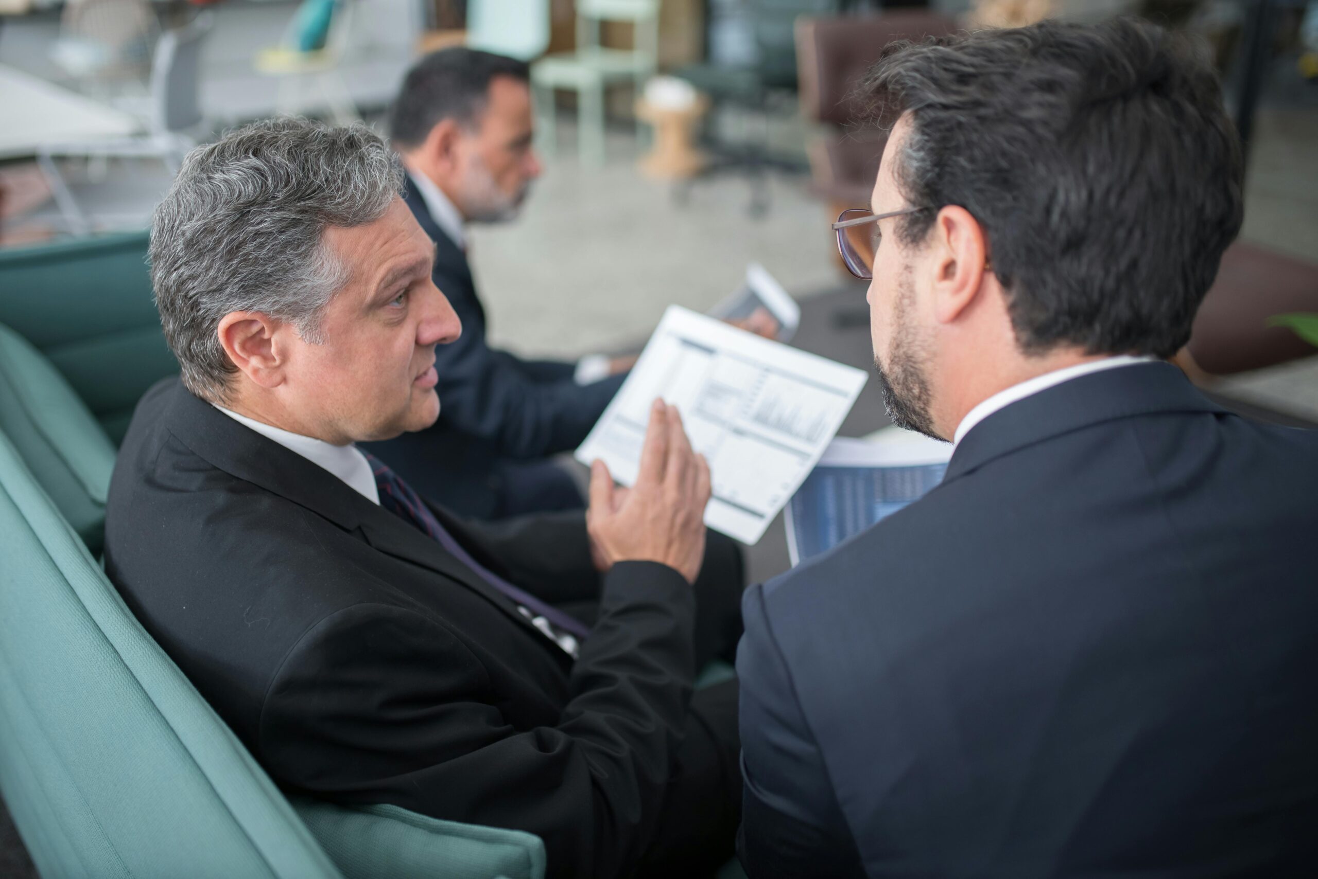 men-sitting-on-sofa-having-a-discussion