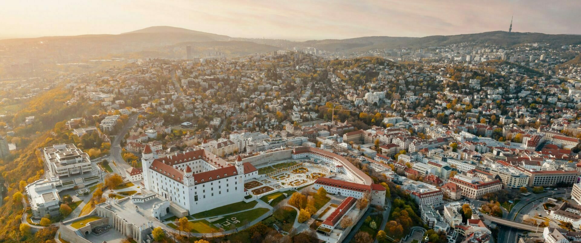 Aerial view of Bratislava, Slovakia, during the day, with the Baroque castle in the foreground.