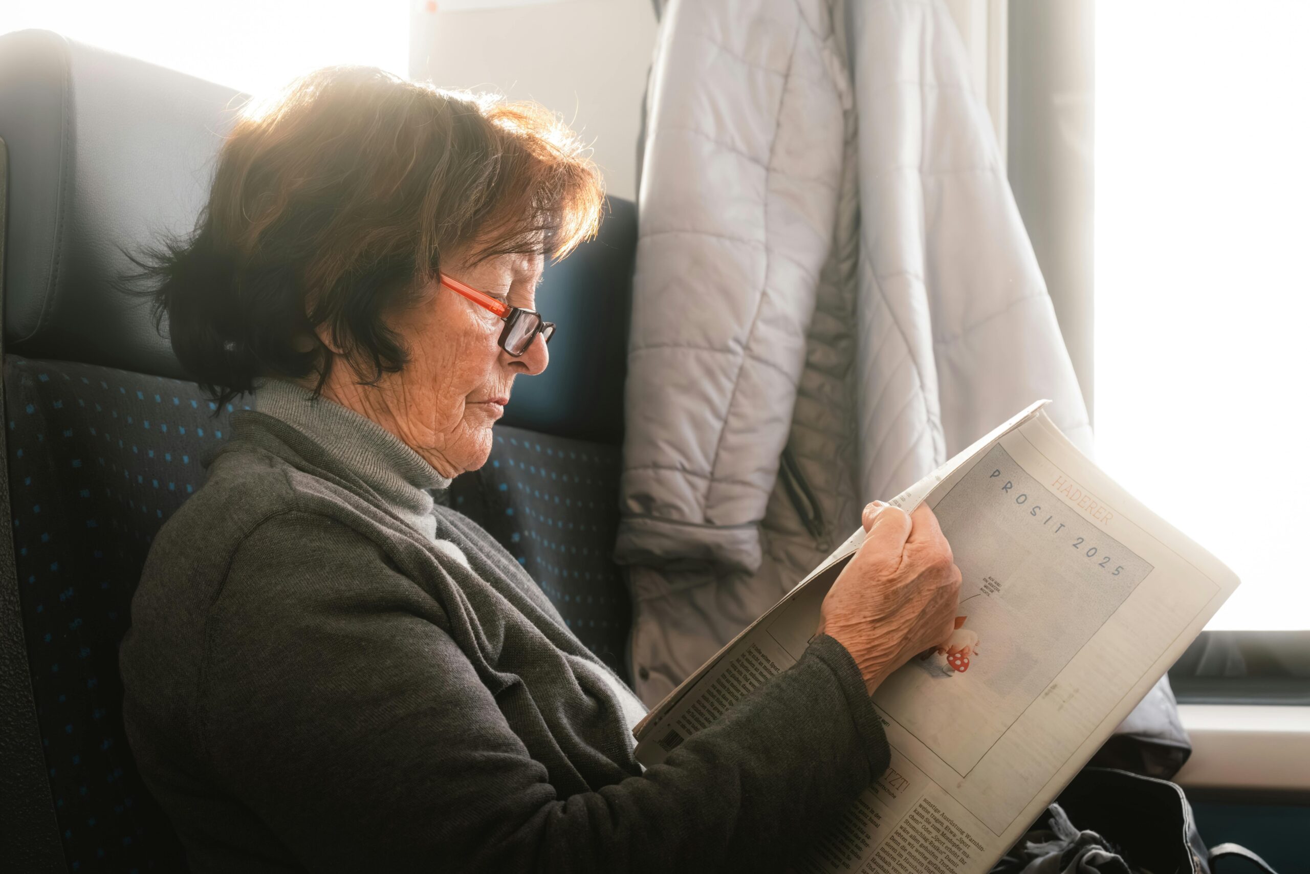 Woman reading papers on train