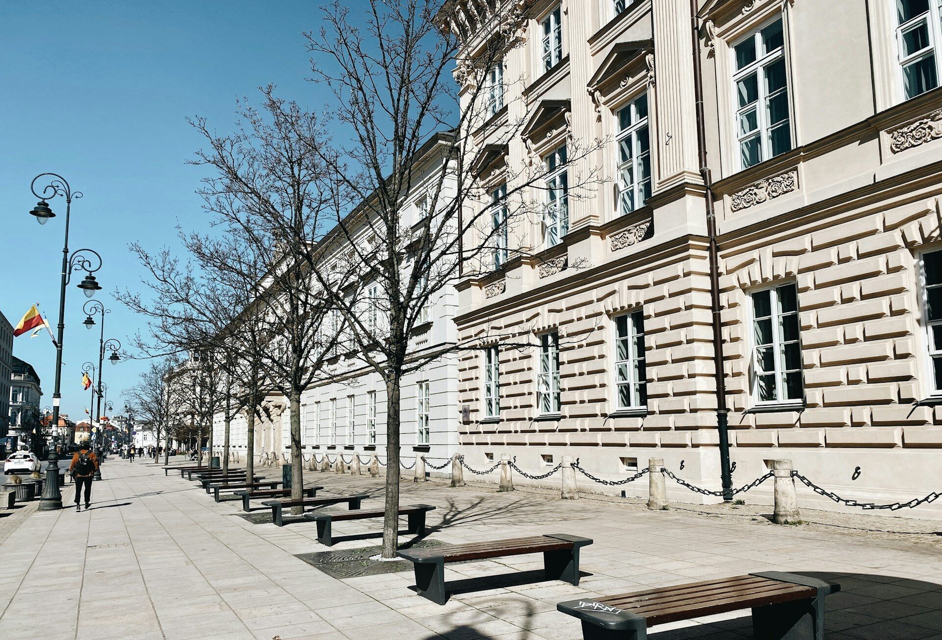 /a-row-of-benches-sitting-on-the-side-of-a-street
