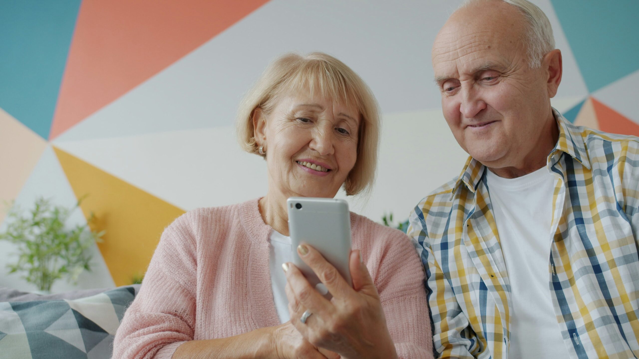Two older adults looking at the mobile phone