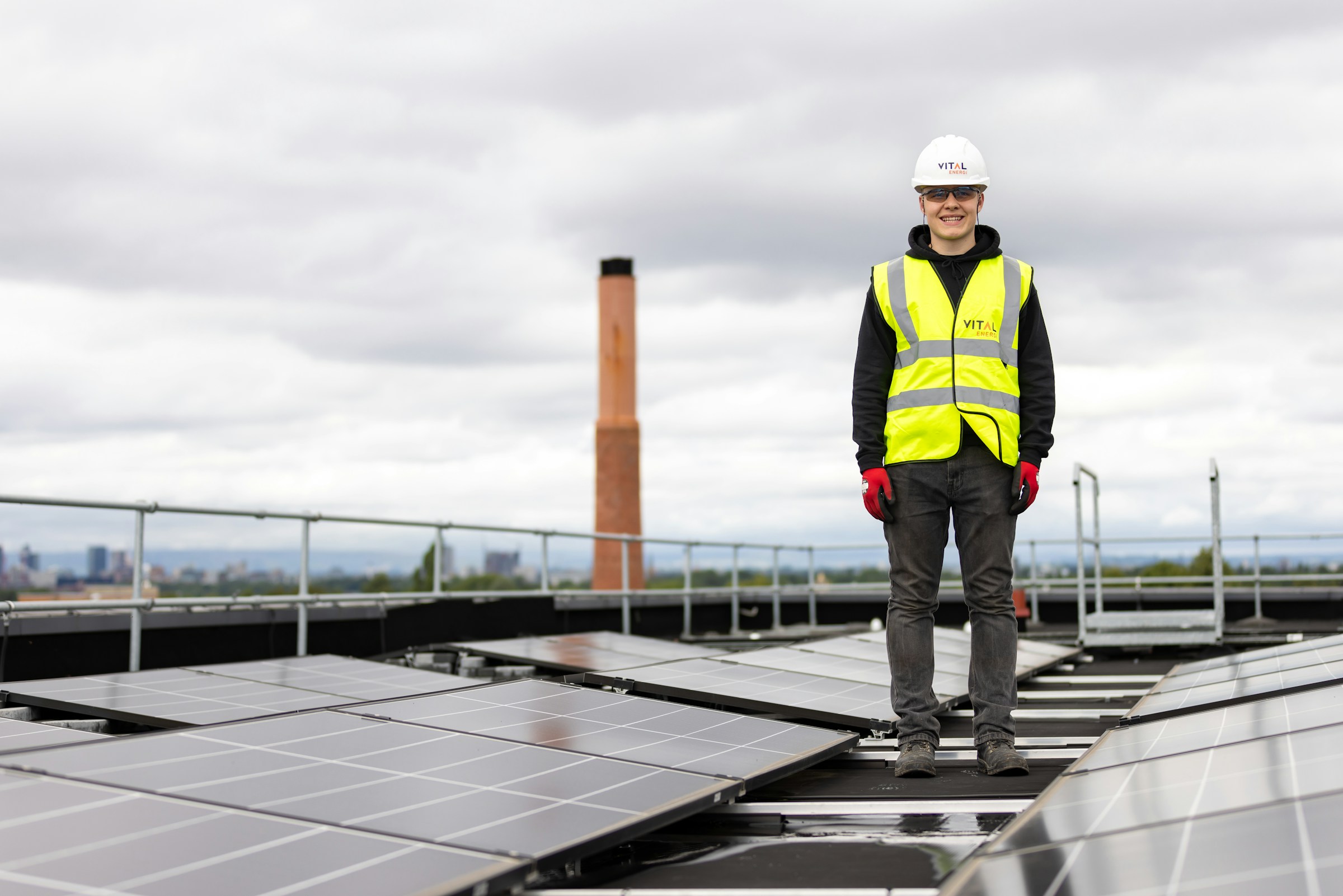 Engineer standing among solar panels