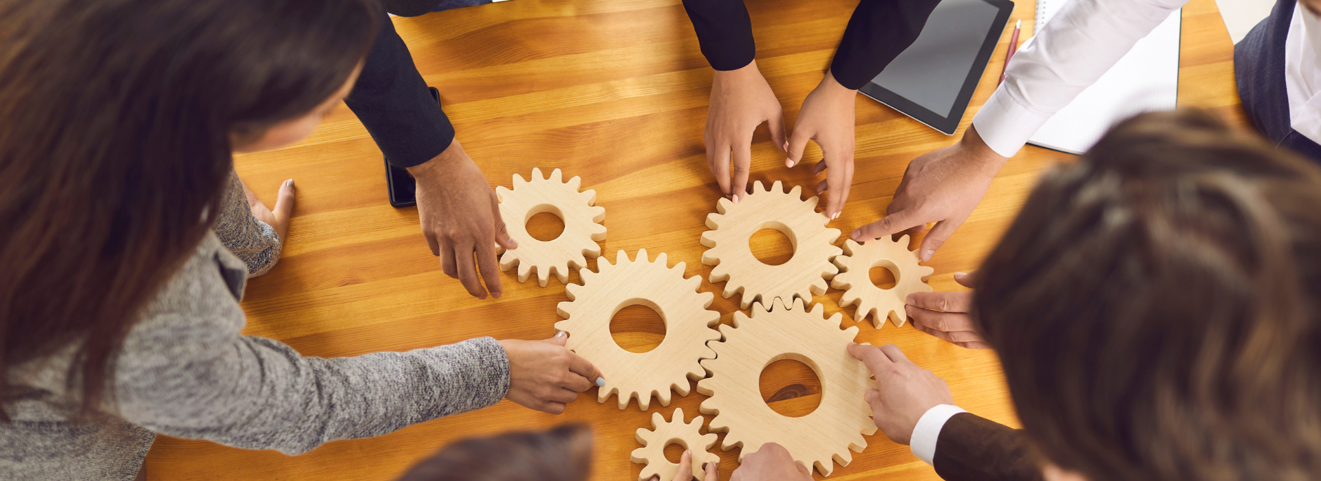 Startup Team Joining Cogwheels as Metaphor for Teamwork, Management and Finding Business Solutions